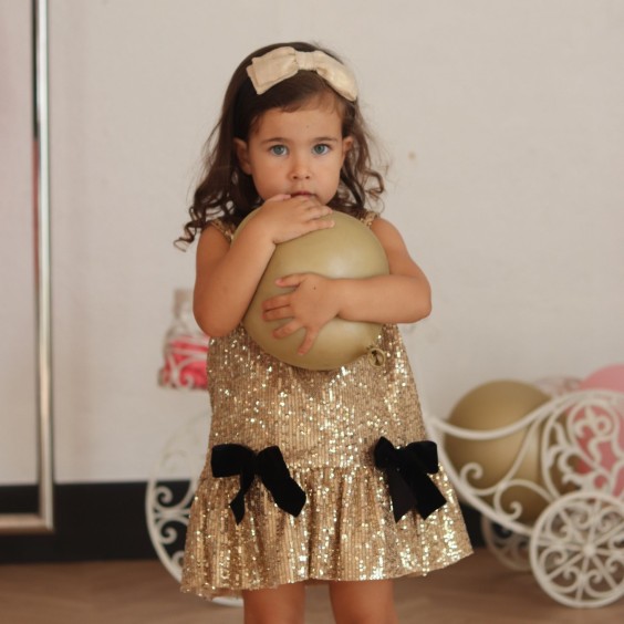 Gold sequins dress with black bows