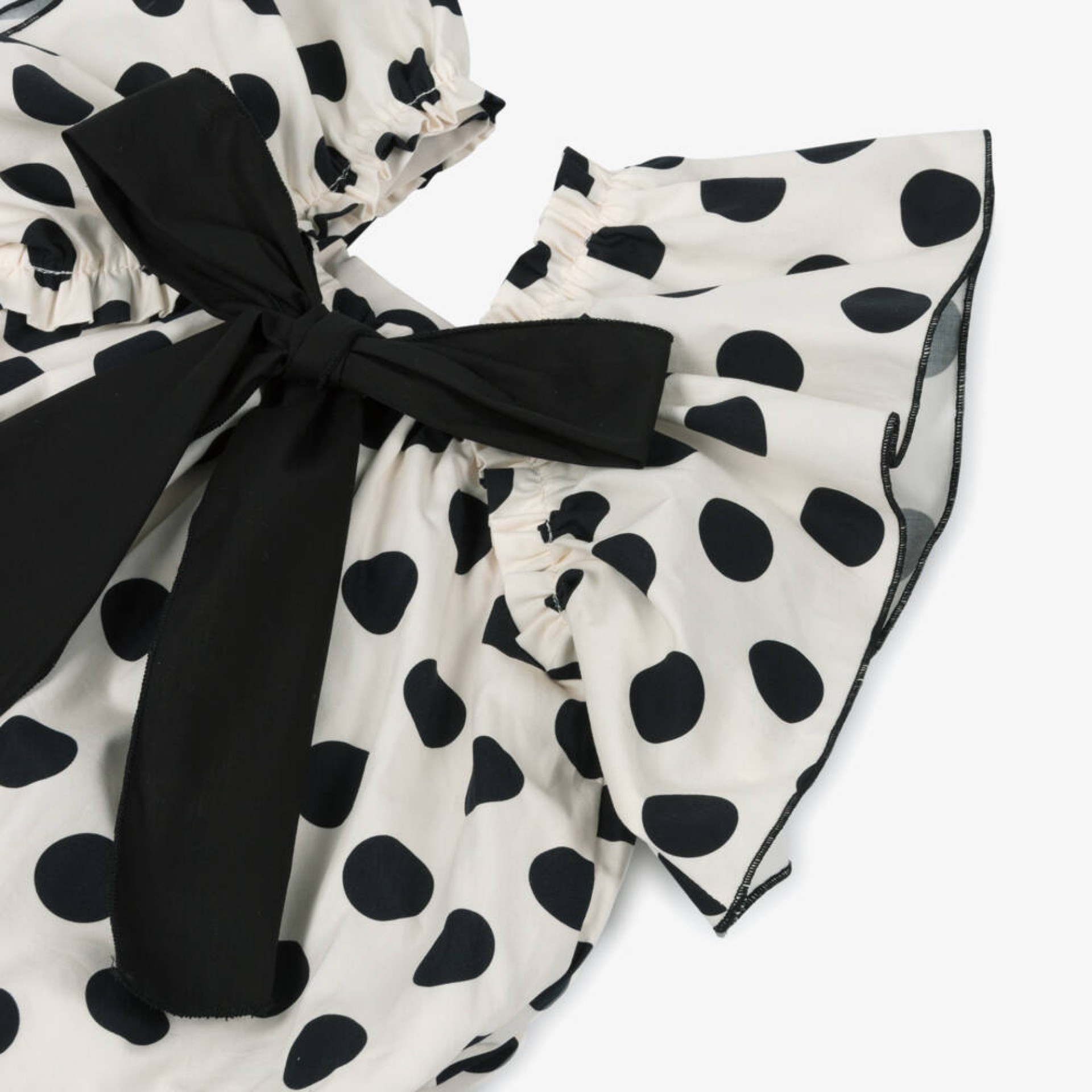 Barboteuse ecru avec boules noires