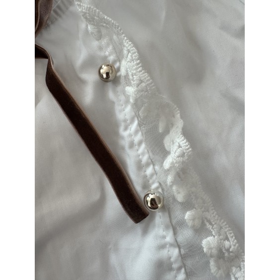 White blouse with tulle ruffle and gold buttons