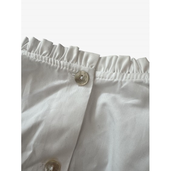 White blouse with tulle ruffle and gold buttons