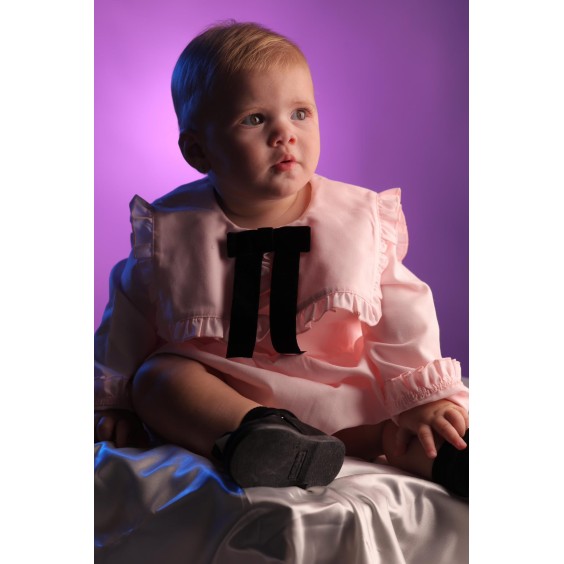 Pink blouse with black velvet bow. 