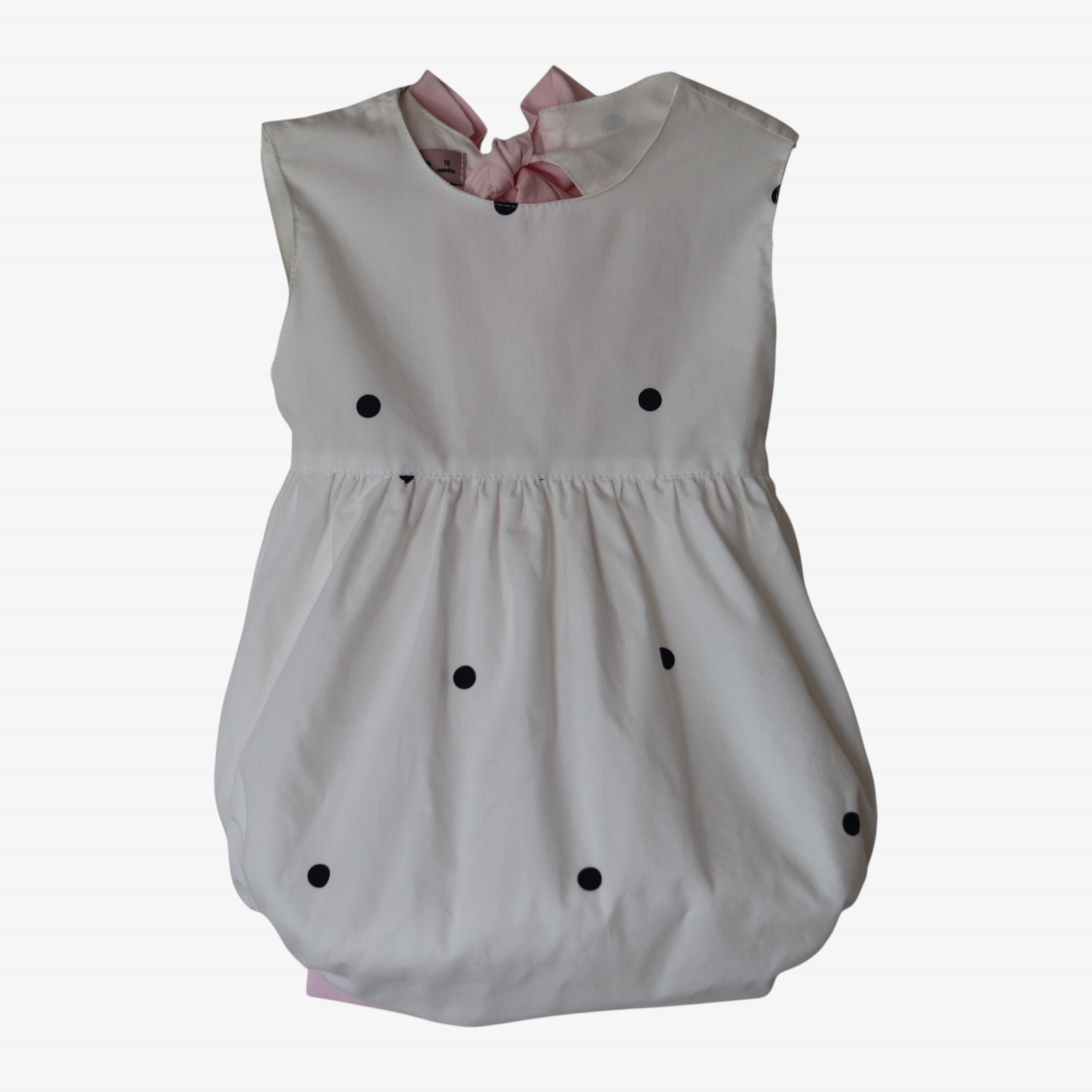 Barboteuse pois noirs avec un nœud rose