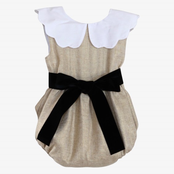 Golden linen romper with a black velvet bow.