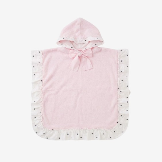 Poncho with black polka dots and a pink bow