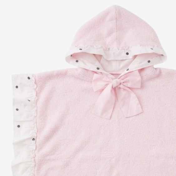 Poncho with black polka dots and a pink bow