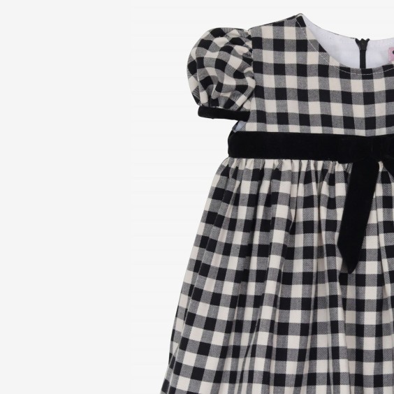 Black and cream square dress with black velvet bow.