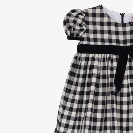 Black and cream square dress with black velvet bow.