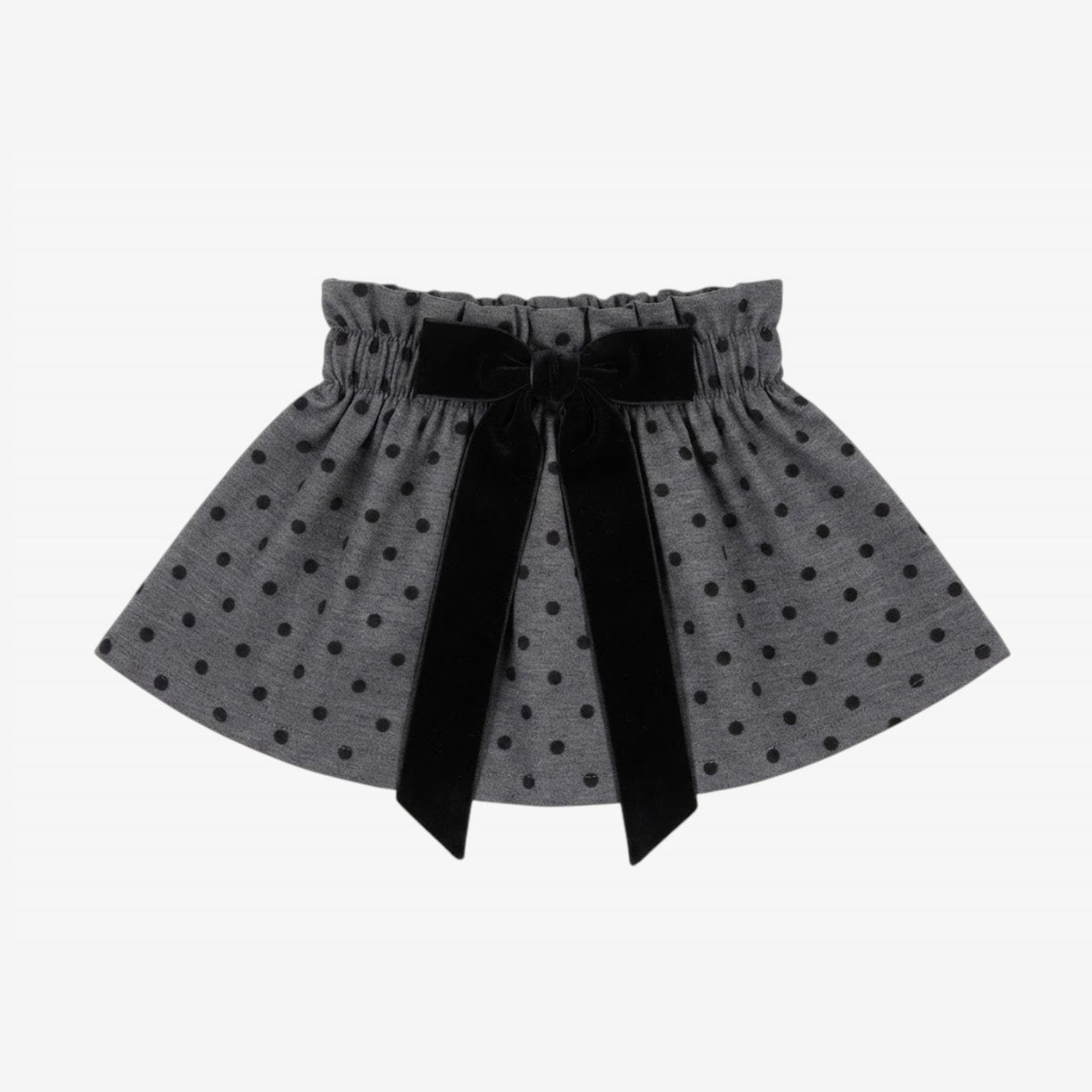 Black skirt with black velvet polka dots and a bow.