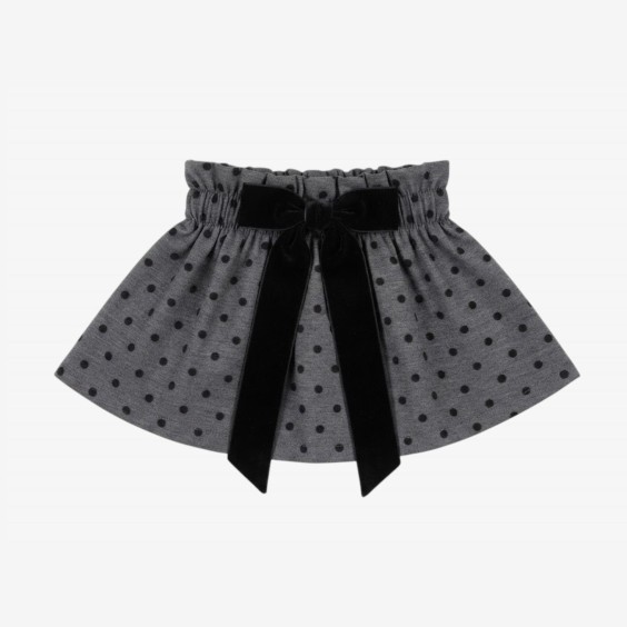 Black skirt with black velvet polka dots and a bow.