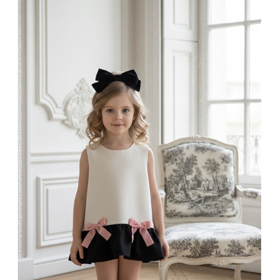 Ivory and black dress with pink bows.