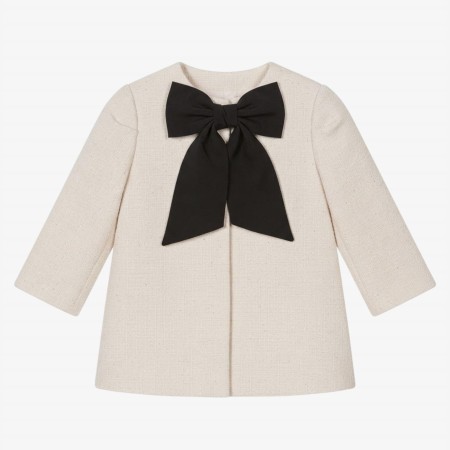 Manteau ivoire avec nœud noir Manteau ivoire avec nœud noir