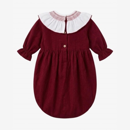 Burgundy velvet romper with a smocked collar.