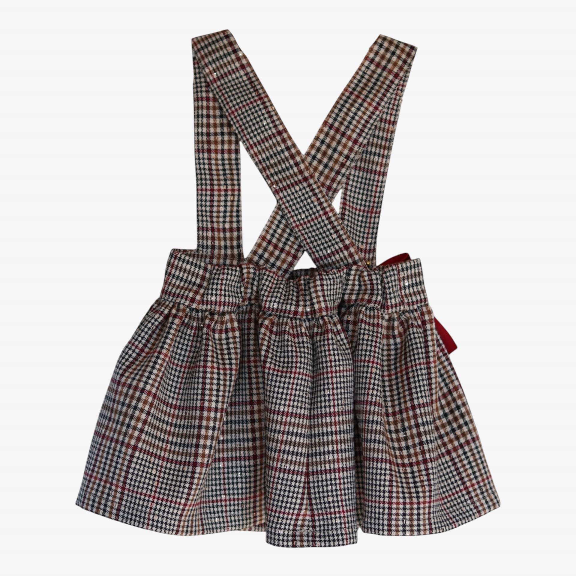 Cream and burgundy checkered skirt with straps and sequins.